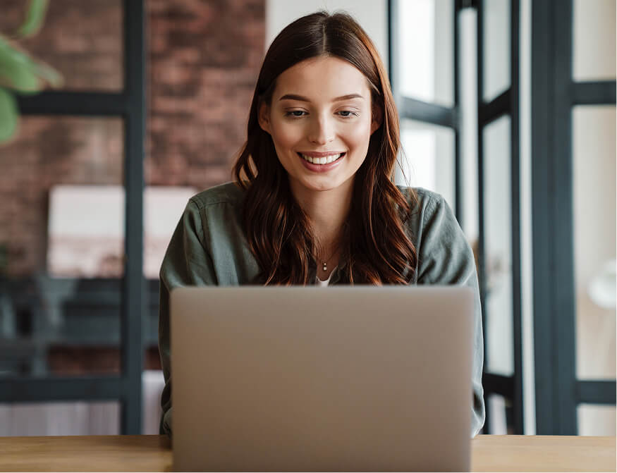 happy women looking at a laptop
